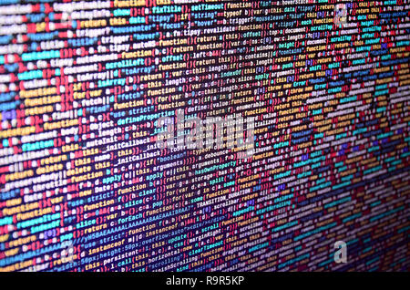 Software developer programming code on computer. Abstract computer script source code. Shallow depth of field, selective focus effect Stock Photo