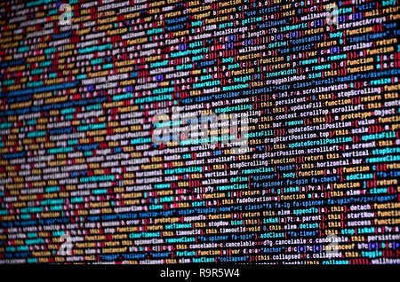 Software developer programming code on computer. Abstract computer script source code. Shallow depth of field, selective focus effect Stock Photo