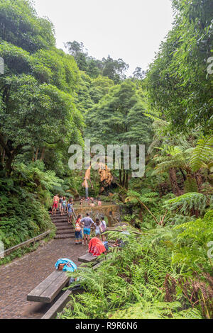 RIBEIRA GRANDE - PORTUGAL, AUGUST 5: Unidentified people bathe in the Caldeira Velha hot springs near Lagoa do Fogo and Ribeira Grande, Portugal on Au Stock Photo