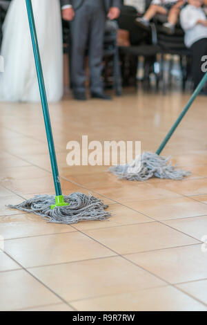 Close up of floor cleaning action with wiper. Cleaning and cleanliness concept. selected focus. vertical photo Stock Photo