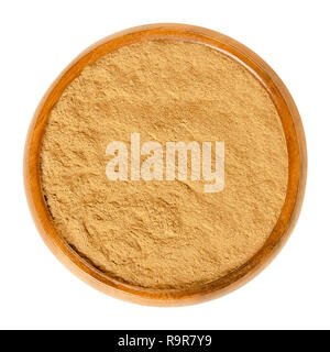 Cinnamon powder in wooden bowl. Spice from inner bark of the Ceylon cinnamon tree, Cinnamomum verum. Brown aromatic condiment and flavoring additive. Stock Photo