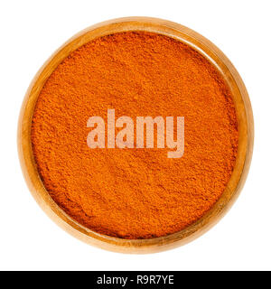 Cayenne pepper powder in wooden bowl. Spice. Moderately hot chili pepper, red color, used to flavor dishes. Dried and ground fruits of Capsicum annuum Stock Photo