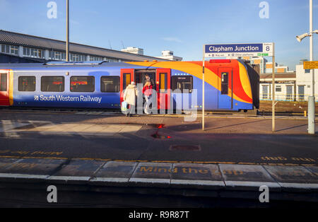 South Western Railway train by a platform name board at Clapham Junction railway station, south-west Battersea, London Borough of Wandsworth Stock Photo