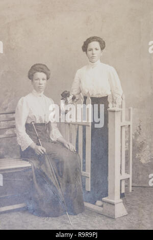RUSSIA - CIRCA 1905-1910: Full body shot of two young women in studio, Vintage Carte de Viste Edwardian era photo Stock Photo