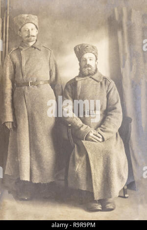 RUSSIA / Latvia - CIRCA 1916-1917: An antique photo shows two Latvian soldiers posing in front of a camera Stock Photo