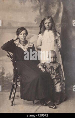 RUSSIA - CIRCA 1905-1910: A portrait of young woman with children in studio, Vintage Carte de Viste Edwardian era photo Stock Photo