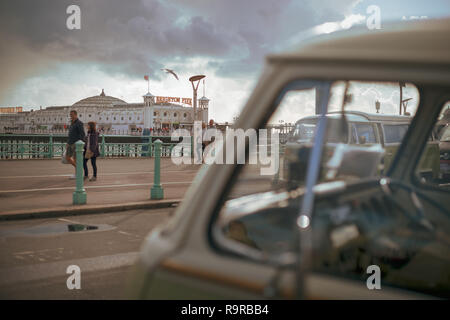 A Volkswagen VW campervan parked on Madeira Drive in Brighton and in front of Brighton Pier in Sussex, England. Stock Photo