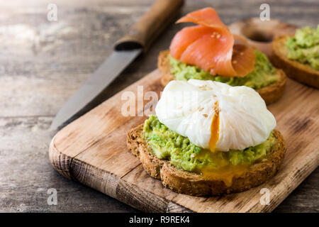 Toasted breads with poached eggs, avocado and salmon Stock Photo