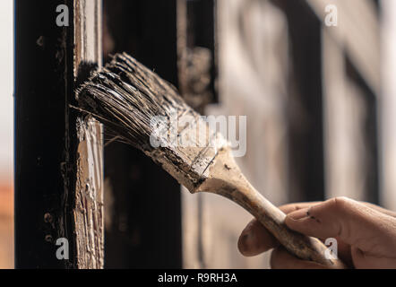 Man hand painting metal door with brush, selective focus Stock Photo