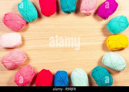 Colorful yarn for knitting on wooden background. Stock Photo