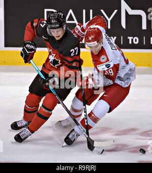 Vancouver. 26th Dec, 2018. Canada's Barrett Hayton (L) and Denmark's Victor Cubars compete during the IIHF World Junior Championships in Vancouver, Dec. 26, 2018. Canada won the preliminary match 14-0. Credit: Andrew Soong/Xinhua/Alamy Live News Stock Photo