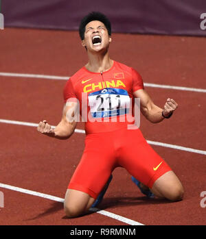 (181227) -- BEIJING, Dec. 27, 2018 (Xinhua) -- Photo taken on Aug. 26, 2018 shows Su Bingtian of China celebrating after the men's 100m final of athletics at the Asian Games 2018 in Jakarta, Indonesia. Su Bingtian (male, 29) clocked an Asian record-equalling 9.91 seconds in Madrid and in Paris. At the Jakarta Asian Games, Su claimed gold with a game-record 9.92 seconds. He also lifted the Asian record in the men's 60m at 6.42 seconds at the 2018 IAAF World Indoor Championships. (Xinhua/Pan Yulong) TOP 10 CHINESE ATHLETES 2018 Stock Photo