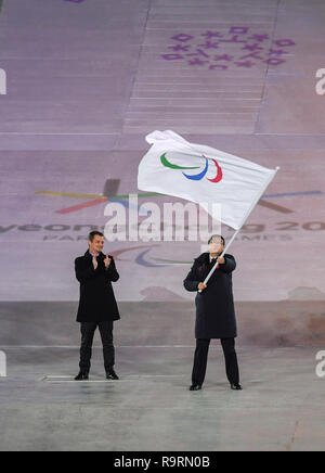 (181227) -- BEIJING, Dec. 27, 2018 (Xinhua) -- Photo taken on March 18, 2018 shows Chen Jining (R), mayor of Beijing, China, waving the Paralympic flag during the closing ceremony of the 2018 PyeongChang Winter Paralympic Games held at PyeongChang Olympic Stadium, South Korea. Beijing took over the Olympic Flag at the closing ceremony of the PyeongChang Olympic and Paralympic Winter Games, marking the start of the Winter Games entering 'Beijing Time.' Beijing issued a worldwide call for mascot designs on Aug. 8 and for opening ceremony proposals on Oct. 15. (Xinhua/Xia Yifang) TOP 10 WORLD SPO Stock Photo