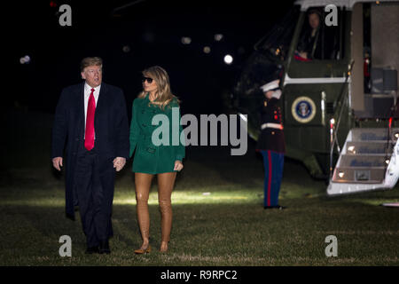 Washington, District of Columbia, USA. 27th Dec, 2018. United States President Donald J. Trump and First Lady Melania Trump make their way across the South Lawn of the White House after returning on Marine One from their surprise trip to Al Asad Air Base in Iraq to visit troops, in Washington, DC, USA, 27 December 2018 Credit: Pete Marovich/CNP/ZUMA Wire/Alamy Live News Stock Photo