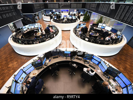 Frankfurt, Germany. 28th Dec, 2018. Stock traders sit on their monitors in the trading room of the Frankfurt Stock Exchange. After the losses on the previous day, share prices rose again on the last trading day of the year. Overall, the German share index (DAX) has lost almost 20 percent since the beginning of the year. Photo: Arne Dedert/dpa Credit: dpa picture alliance/Alamy Live News Stock Photo