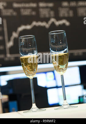 Frankfurt, Germany. 28th Dec, 2018. Champagne glasses are placed in front of the display board with the Dax curve in the trading room of the Frankfurt Stock Exchange. After the losses on the previous day, share prices rose again on the last trading day of the year. Overall, the German share index (DAX) has lost almost 20 percent since the beginning of the year. Photo: Arne Dedert/dpa Credit: dpa picture alliance/Alamy Live News Stock Photo