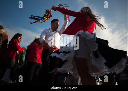 Malaga, Spain. 28th Dec, 2018. Participants dressed in traditional costumes seen dancing on the street before taking part in the 57th edition of Verdiales Flamenco Dance contest in Malaga.The Verdiales celebration is an important music and cultural festival in Malaga from rural origin, celebrated annually on 28 December for the Fools Saints Day. Participants of different musical groups, known as ''pandas'', perform by singing and dancing in a style of flamenco music called ''Verdiales'' with musical instruments, typical of the Andalusian popular folklore. (Credit Image: © Jesus Merida/SO Stock Photo