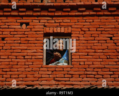 Bhaktapur, Nepal. 28th Dec, 2018. A woman views Navadurga Festival from her window in Bhaktapur, Nepal, on Dec. 28, 2018. Credit: Sulav Shrestha/Xinhua/Alamy Live News Stock Photo