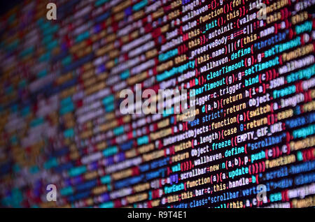 Software developer programming code on computer. Abstract computer script source code. Shallow depth of field, selective focus effect Stock Photo