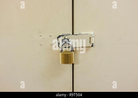 Padlock on closed metal door. Stock Photo