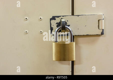 Padlock on closed metal door. Stock Photo