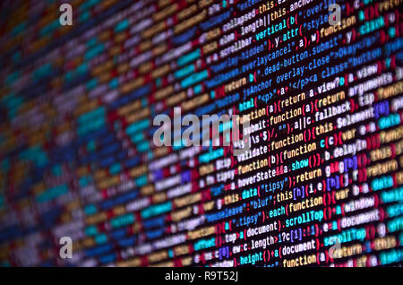 Software developer programming code on computer. Abstract computer script source code. Shallow depth of field, selective focus effect Stock Photo