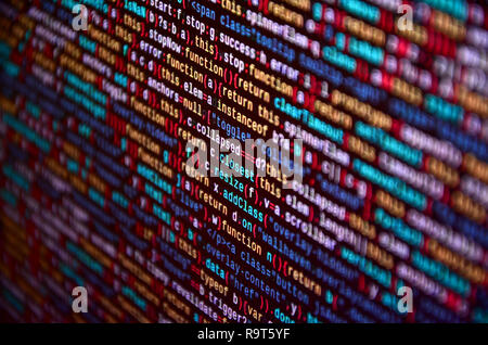 Software developer programming code on computer. Abstract computer script source code. Shallow depth of field, selective focus effect Stock Photo