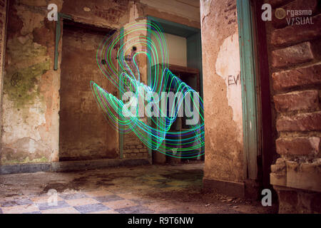 Abandoned house and abstract figures of light painting. Stock Photo