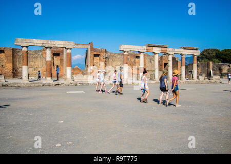 Tourists visiting Roman Forum, Colonnade, Pompeii, Campania Italy, pompeii ruins UNESCO site, roman concept, history, archeology, europe, top sites Stock Photo