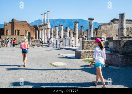 Tourists visiting Roman Forum, Colonnade, Pompeii, Campania Italy, pompeii ruins UNESCO site, roman concept, history, archeology, europe, top sites Stock Photo