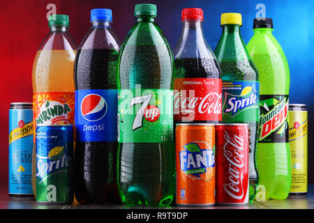 Bottles and cans of assorted global soft drinks Stock Photo - Alamy