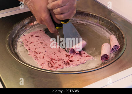 Premium Photo  Stir-fried ice cream rolls at freeze pan. rolled ice cream,  hand made ice cream dessert. fried ice cream machine with steel chilled pan.