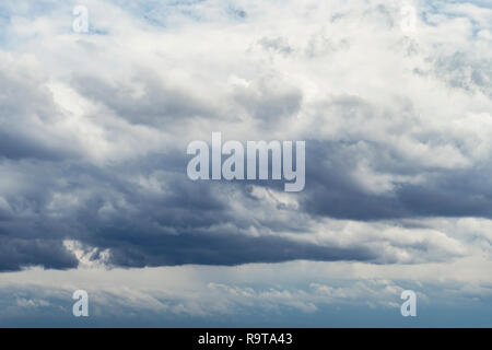 Dramatic sky with stormy clouds. many white Cumulus clouds in the sky in the evening light. Stock Photo