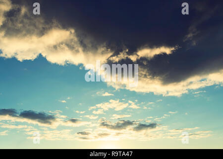 black cloud like storm, dramatic sky. Big black gloomy rain cloud in the sky over the cloudless blue sky. bad weather Stock Photo