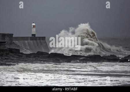 Pictured: Waves crash against the promenade wall by the lighthouse in Porthcawl, south Wales, UK. Tuesday 18 December 2018 Re: Heavy rain has been for Stock Photo