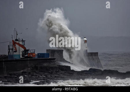 Pictured: Waves crash against the promenade wall by the lighthouse in Porthcawl, south Wales, UK. Tuesday 18 December 2018 Re: Heavy rain has been for Stock Photo