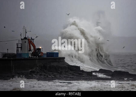 Pictured: Waves crash against the promenade wall by the lighthouse in Porthcawl, south Wales, UK. Tuesday 18 December 2018 Re: Heavy rain has been for Stock Photo