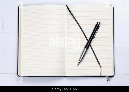 White notepad notebook lines elegant pen grey wooden background Stock Photo