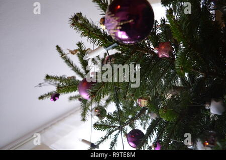 Christmas tree with decoration and ornaments shot from below, amazing perspective Stock Photo