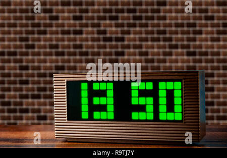electronic clock on the surface on a brick wall texture background Stock Photo