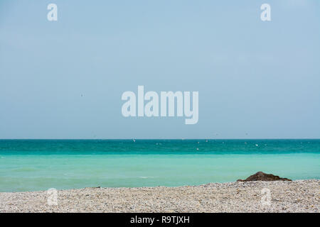 Lonely beach in Benicassim, Castellon, Spain, just with a rock in the composition, with turquoise water. Copy space. Background image Stock Photo