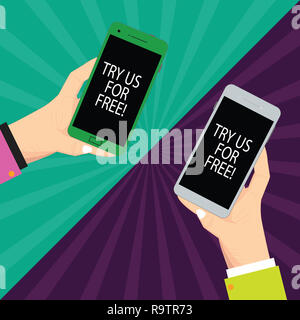 Text sign showing Try Us For Free. Conceptual photo Trial at not any cost Offer promotion big discount Two Hu analysis Hands Each Holding Blank Smartp Stock Photo