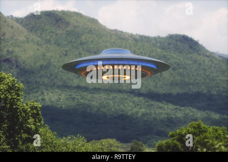 Unidentified flying object over a forest with trees and mountains behind. Stock Photo