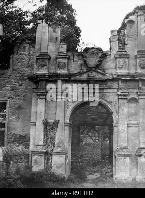 Black and white photograph taken in 1920 showing part of the ruins of Elstow Abbey in Bedfordshire, England. Elstow Abbey was a monastery for Benedictine nuns in Elstow, Bedfordshire, England. It was founded c.1075 by Judith, Countess of Huntingdon, a niece of William the Conqueror, and therefore is classed as a royal foundation. Photograph shows ruins overgrown at the time that the image was taken. Today they are much clearer.