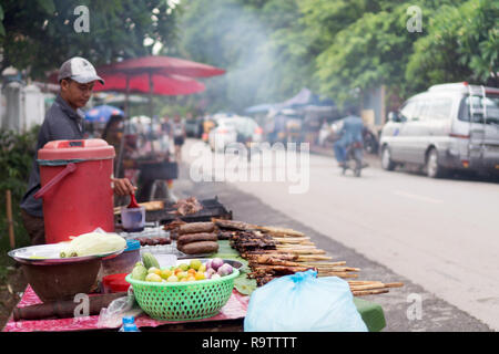 Luang Prabang Street Food Stall Selling Grilled Meats on a Stick and other local traditional foods, Laos Stock Photo