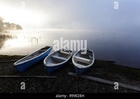 Small blue boats beside a Lake, with Mount Fuji behind, Central Honshu, Japan Stock Photo