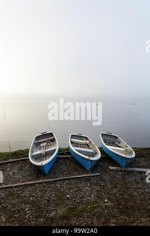 Small blue boats beside a Lake, with Mount Fuji behind, Central Honshu, Japan Stock Photo