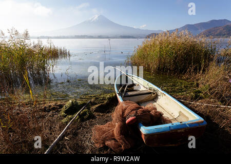 Small blue boats beside a Lake, with Mount Fuji behind, Central Honshu, Japan Stock Photo