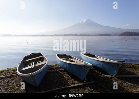 Small blue boats beside a Lake, with Mount Fuji behind, Central Honshu, Japan Stock Photo