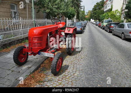 Tractor parks on street in the city of Munich, Germany Stock Photo